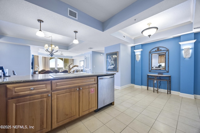 kitchen with pendant lighting, sink, dishwasher, a raised ceiling, and a chandelier