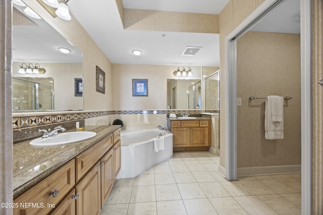 bathroom with tasteful backsplash, tile patterned floors, shower with separate bathtub, and vanity