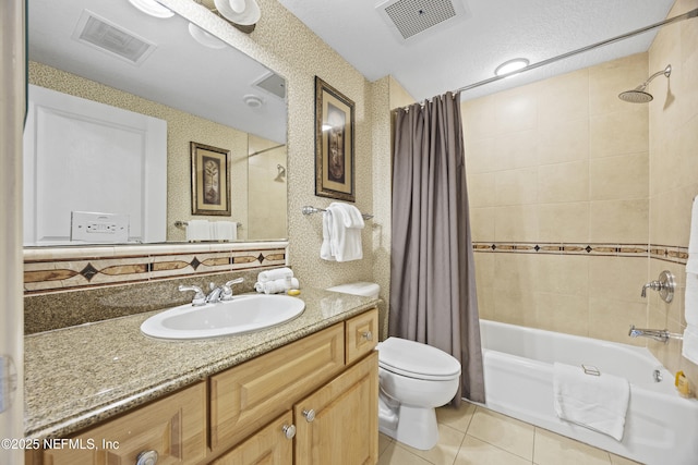 full bathroom with toilet, a textured ceiling, vanity, shower / bathtub combination with curtain, and tile patterned flooring