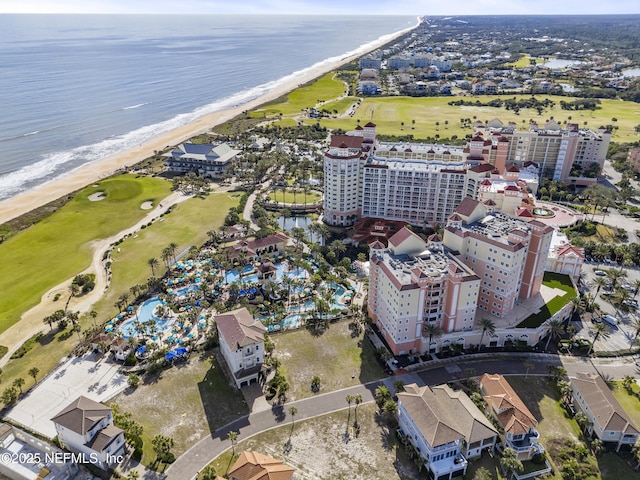 birds eye view of property with a water view and a view of the beach