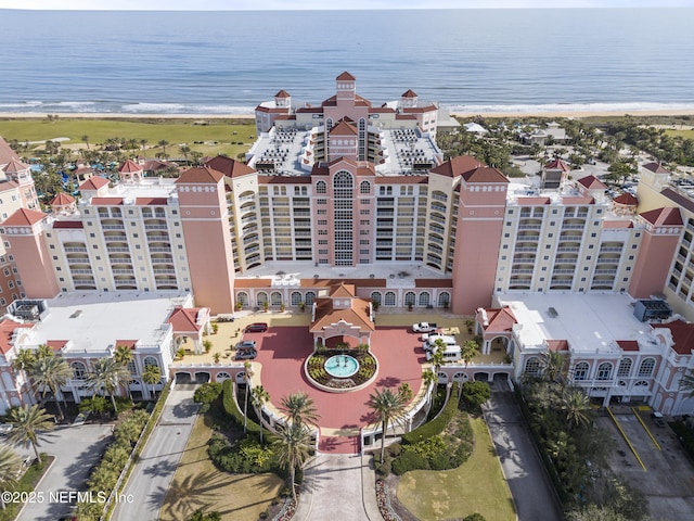 drone / aerial view with a water view and a beach view