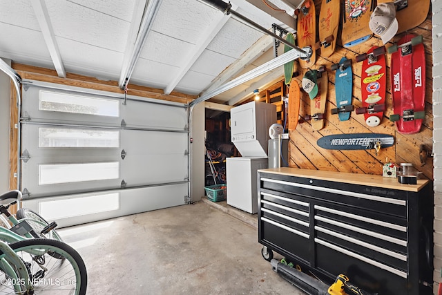 garage featuring stacked washer and dryer