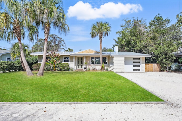 ranch-style house with a garage, a front yard, and covered porch