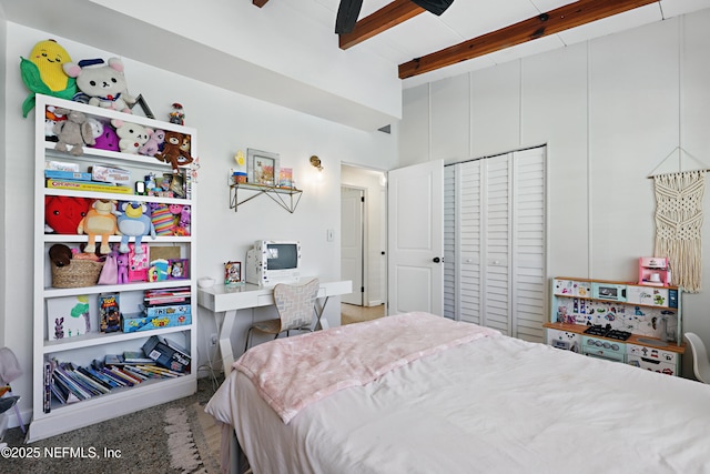 bedroom with beamed ceiling and a closet