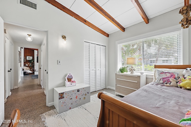 bedroom with a closet and vaulted ceiling with beams