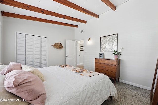 bedroom with beamed ceiling and a closet