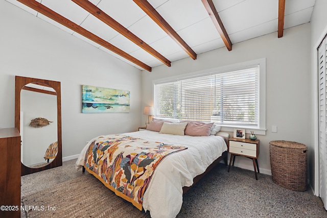 bedroom featuring vaulted ceiling with beams