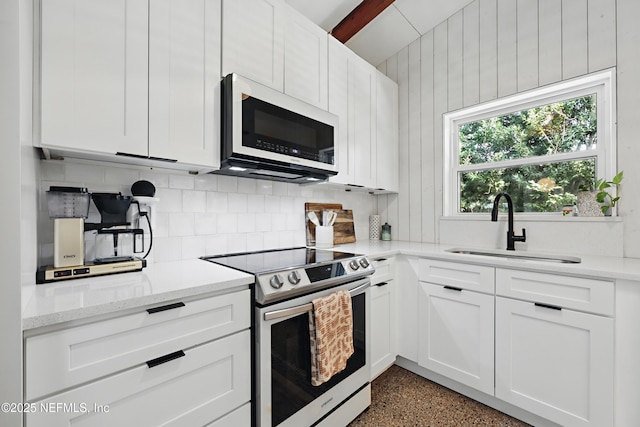 kitchen featuring sink, stainless steel range with electric cooktop, and white cabinets