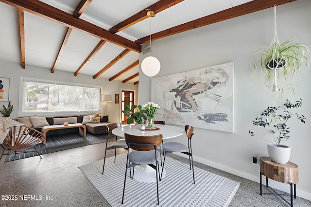 dining area with vaulted ceiling with beams