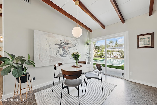 dining space featuring beam ceiling and high vaulted ceiling