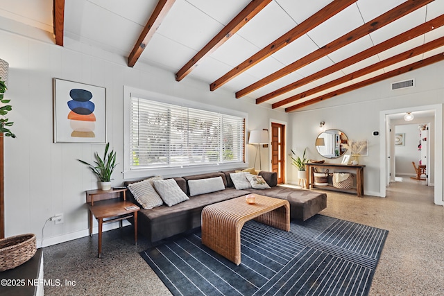 living room with vaulted ceiling with beams