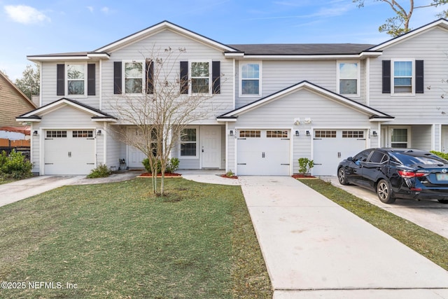 view of front of property with a garage and a front lawn