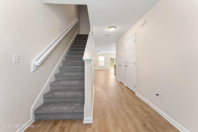 stairway featuring hardwood / wood-style floors