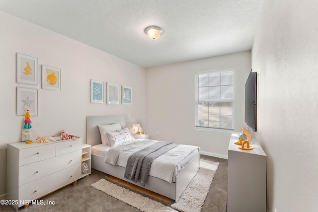 bedroom with carpet and a textured ceiling