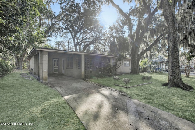 exterior space featuring a front lawn and a carport