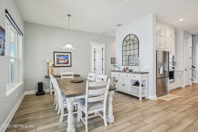 dining space with light hardwood / wood-style floors