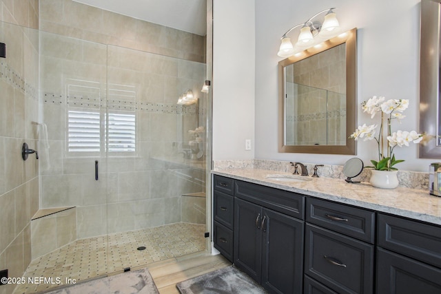 bathroom featuring vanity and an enclosed shower