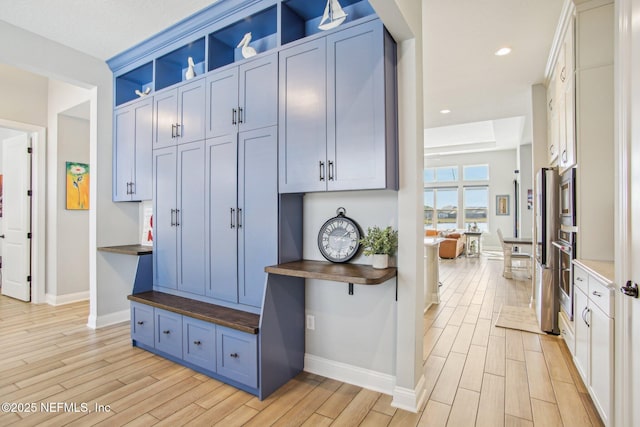 mudroom with light hardwood / wood-style floors