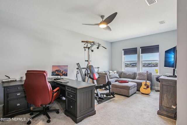 office space featuring light colored carpet and ceiling fan