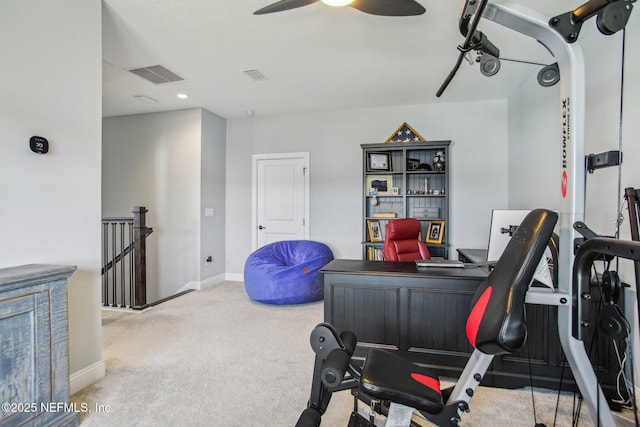 workout area featuring light carpet and ceiling fan