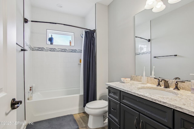 full bathroom with shower / tub combo, vanity, hardwood / wood-style flooring, and toilet