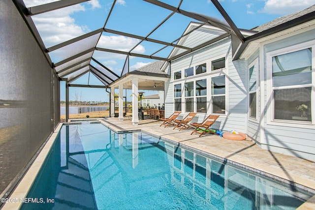 view of swimming pool featuring a patio and glass enclosure