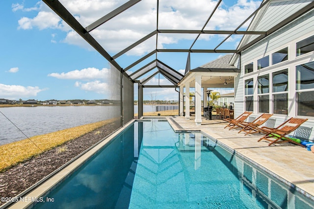 view of swimming pool featuring a patio, a water view, and a lanai