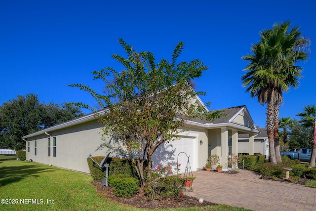 view of home's exterior featuring a garage and a yard