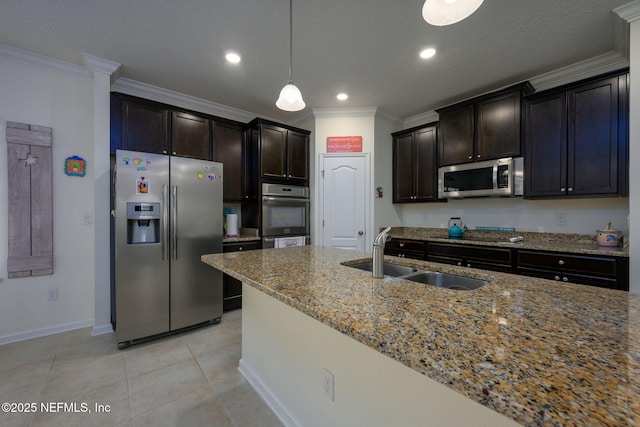 kitchen featuring sink, light stone counters, hanging light fixtures, ornamental molding, and stainless steel appliances