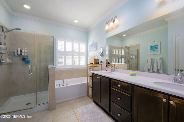 bathroom featuring ornamental molding, tile patterned floors, independent shower and bath, and vanity