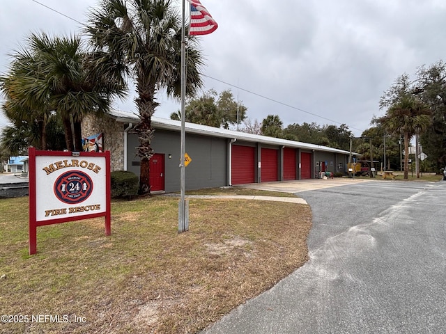 exterior space featuring a garage and a front yard