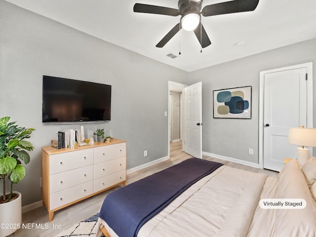 bedroom with ceiling fan and light hardwood / wood-style floors