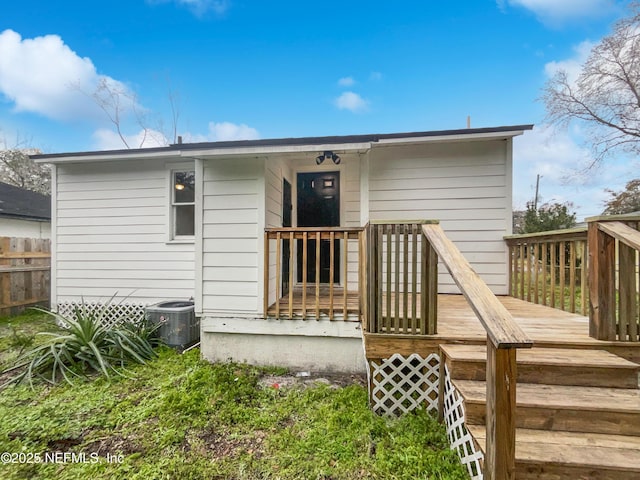 back of house featuring central AC and a wooden deck