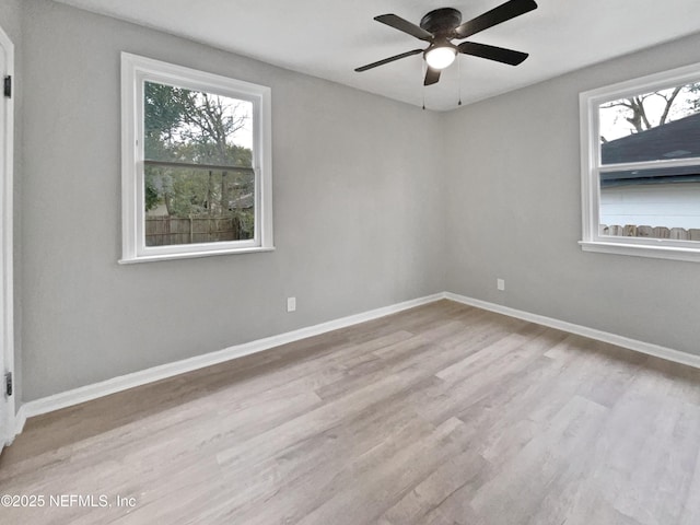 empty room featuring ceiling fan and light hardwood / wood-style floors