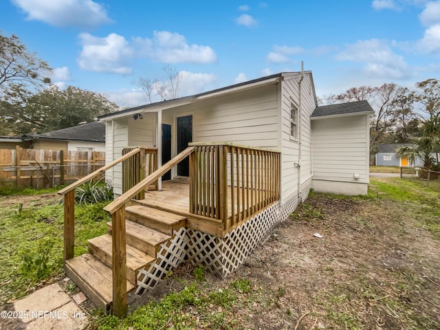 rear view of property featuring a deck