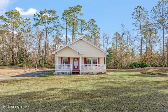 view of front of property featuring a front yard and covered porch