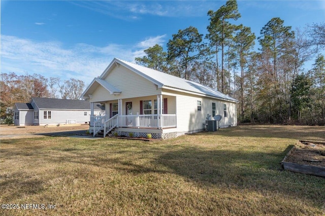 view of front of house with a porch, a front yard, and central AC unit