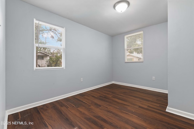 empty room featuring dark hardwood / wood-style flooring