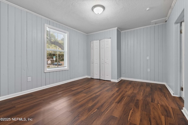 unfurnished bedroom with dark hardwood / wood-style flooring, a closet, and a textured ceiling