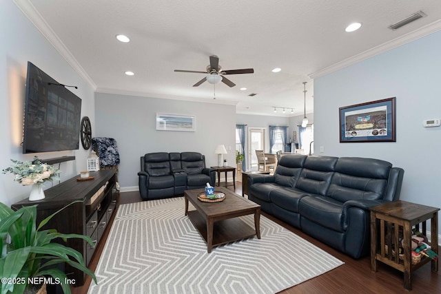 living room with crown molding, ceiling fan, and dark hardwood / wood-style flooring