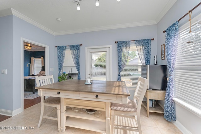 dining room featuring crown molding and light tile patterned flooring