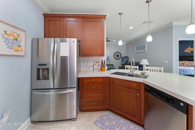 kitchen with sink, light tile patterned floors, ornamental molding, appliances with stainless steel finishes, and pendant lighting