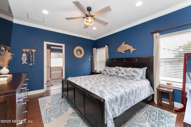 bedroom featuring ornamental molding, dark hardwood / wood-style floors, ceiling fan, and ensuite bath