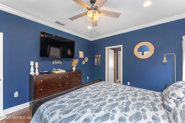 bedroom featuring ceiling fan, ornamental molding, and dark hardwood / wood-style floors