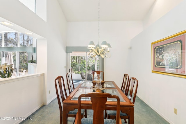 carpeted dining room with a high ceiling and a chandelier