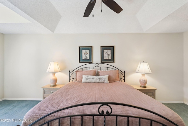 bedroom with ceiling fan, a textured ceiling, and dark colored carpet