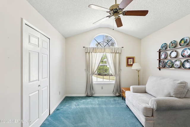 sitting room with lofted ceiling, a textured ceiling, ceiling fan, and carpet flooring