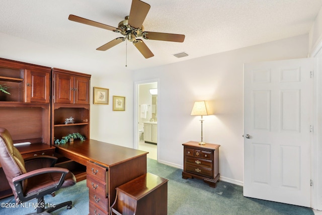 office space with ceiling fan, a textured ceiling, and dark colored carpet