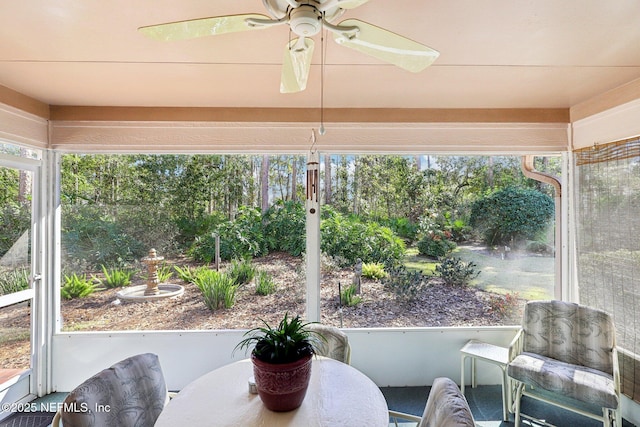 sunroom featuring a ceiling fan