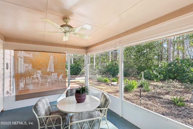 sunroom / solarium featuring ceiling fan